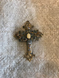 Metal cross with leaf filigree and small Mary on front